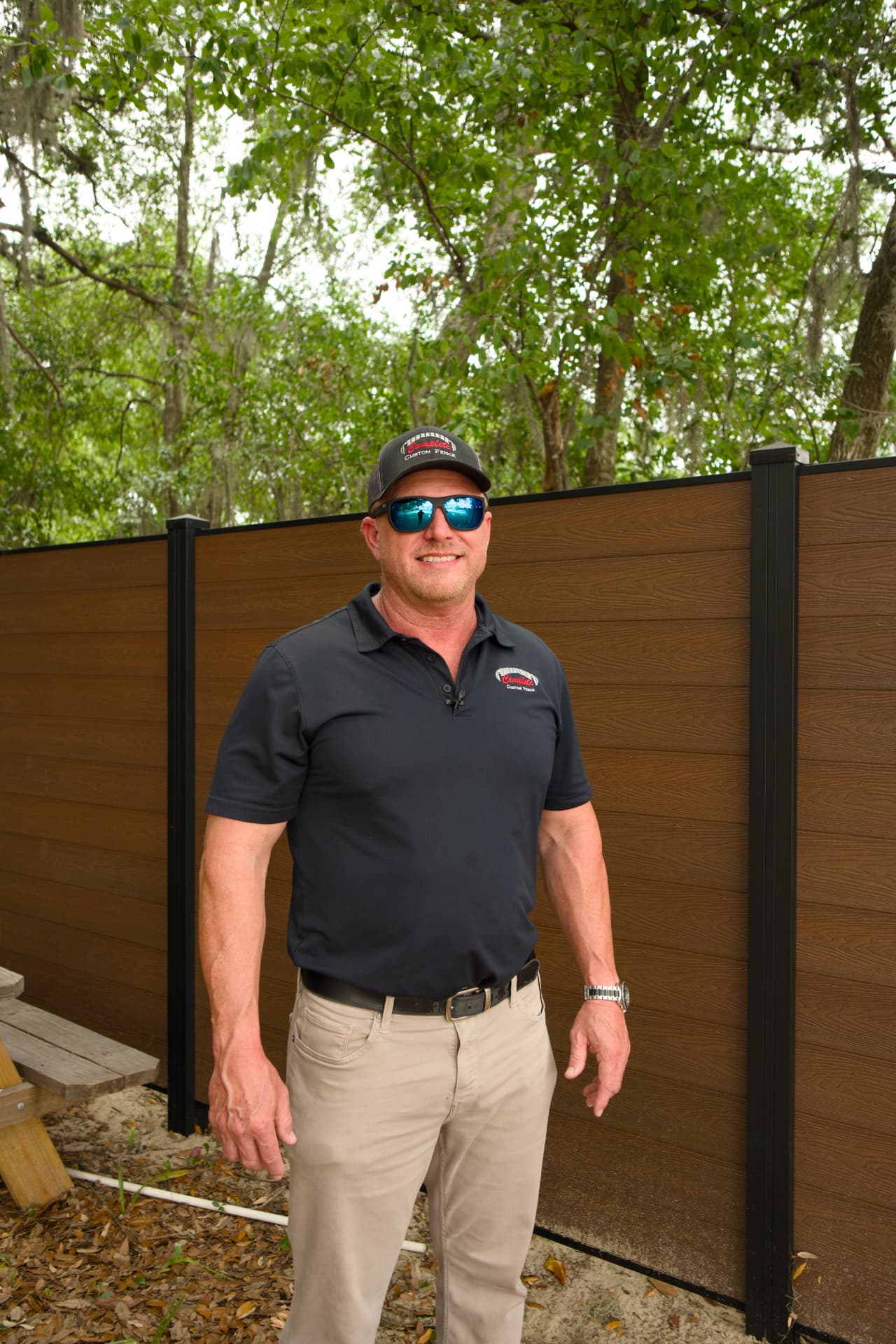Owner Luke Payne in front of a finished vinyl privacy fence